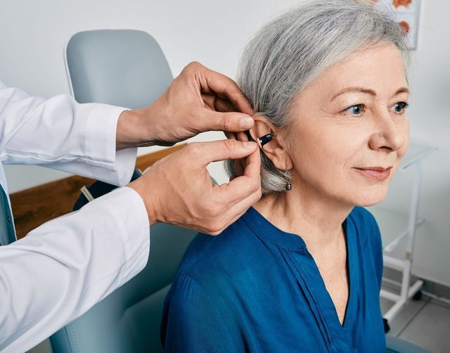 Audiologist Installing Hearing Aid — Brooklyn, NY — Urban Hearing
