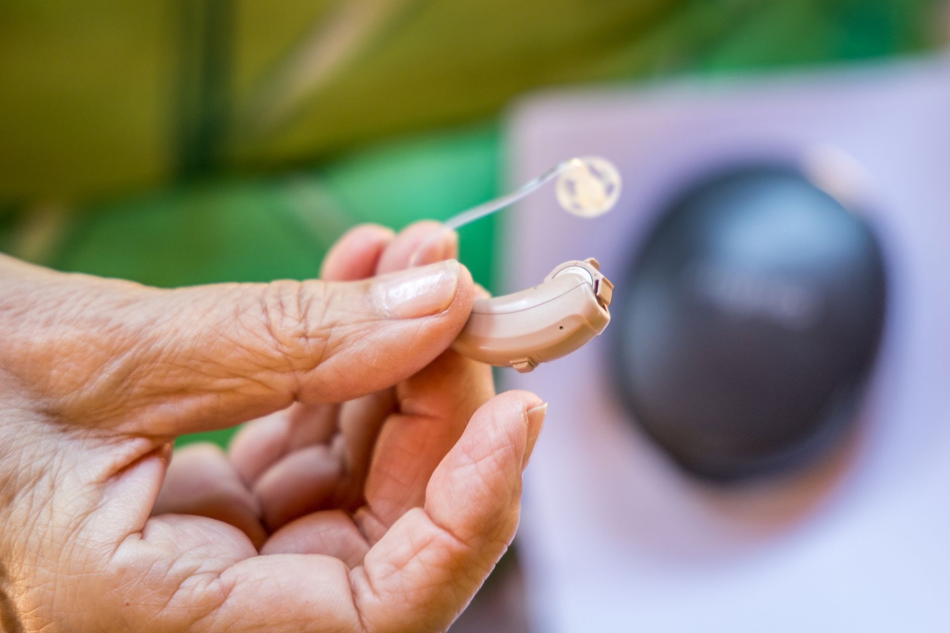 A Hand Holding Hearing Aid — Brooklyn, NY — Urban Hearing