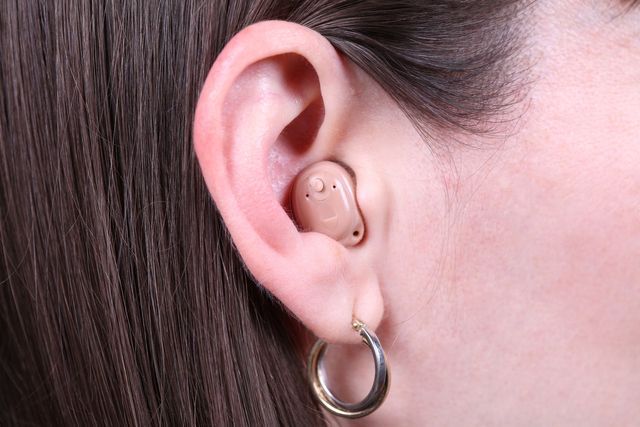 Audiologist Installing Hearing Aid — Brooklyn, NY — Urban Hearing