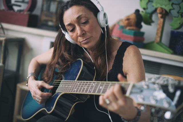 Woman Playing Guitar — Brooklyn, NY — Urban Hearing