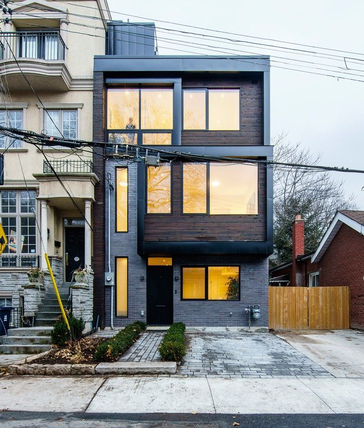 A large building with a lot of windows and a fence in front of it