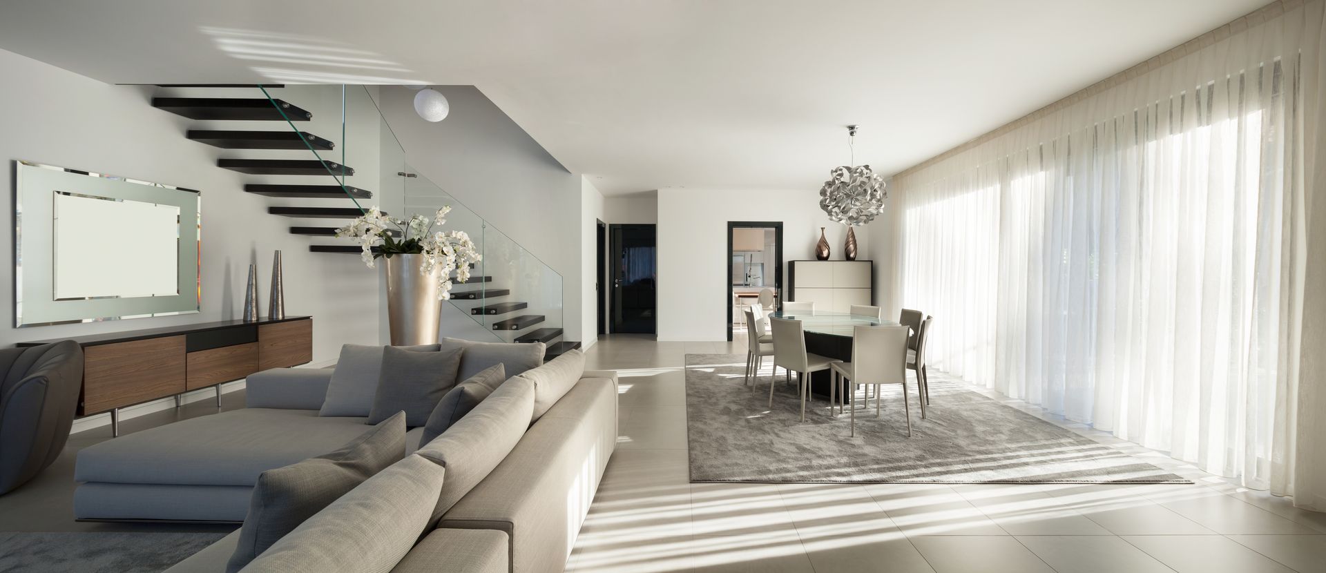 A living room with a couch and stairs in the background