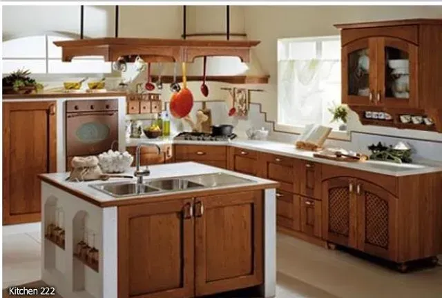 Wooden kitchen with island, cabinets, stove, and oven. Beige walls, white countertops.