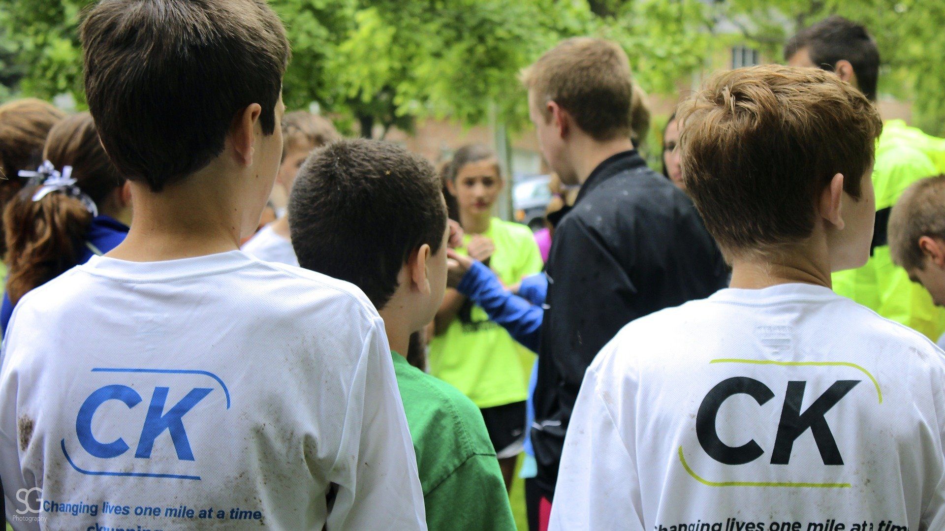 Two boys wearing ck shirts are standing next to each other