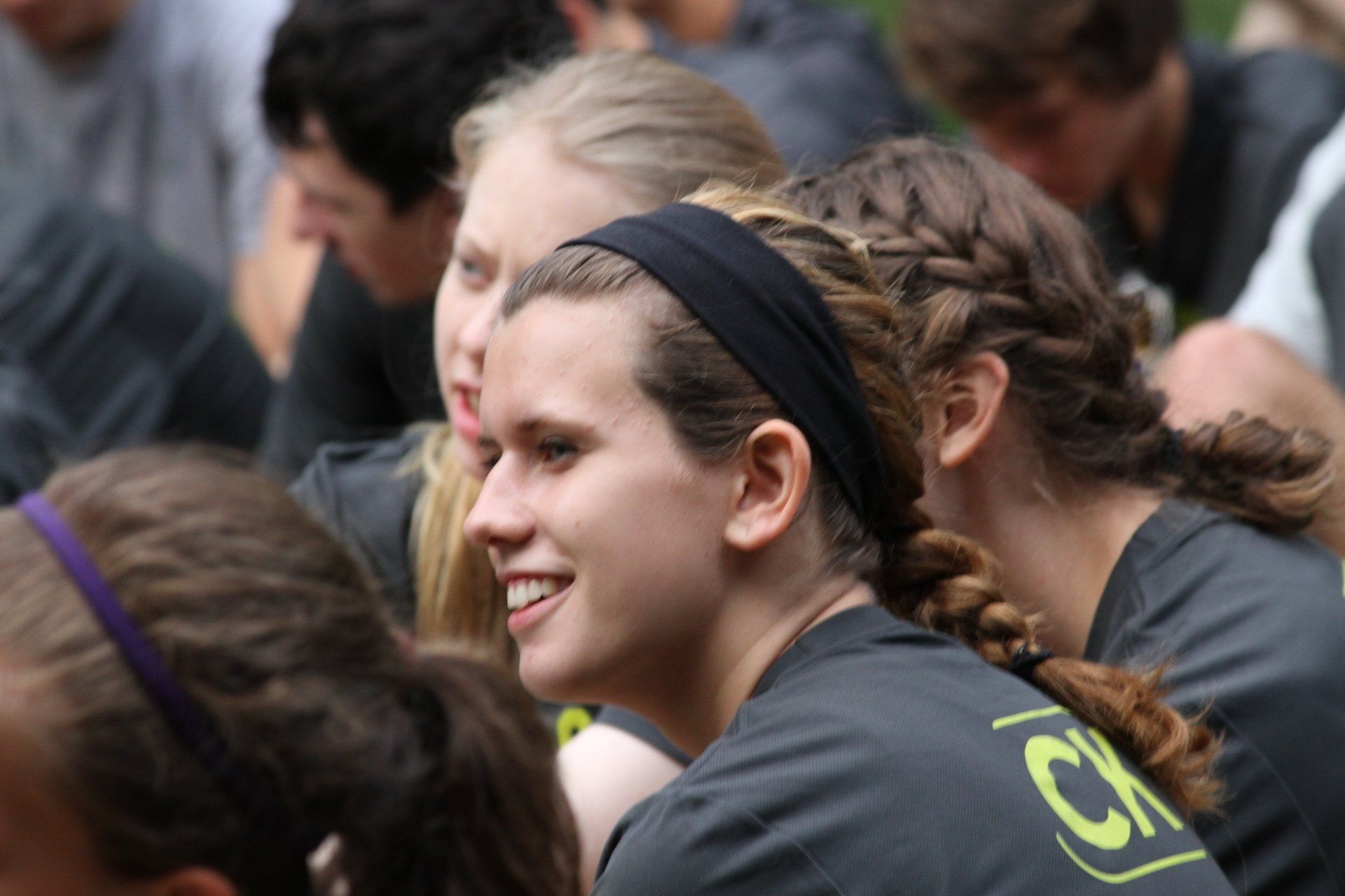 A girl wearing a headband with the letter ck on it