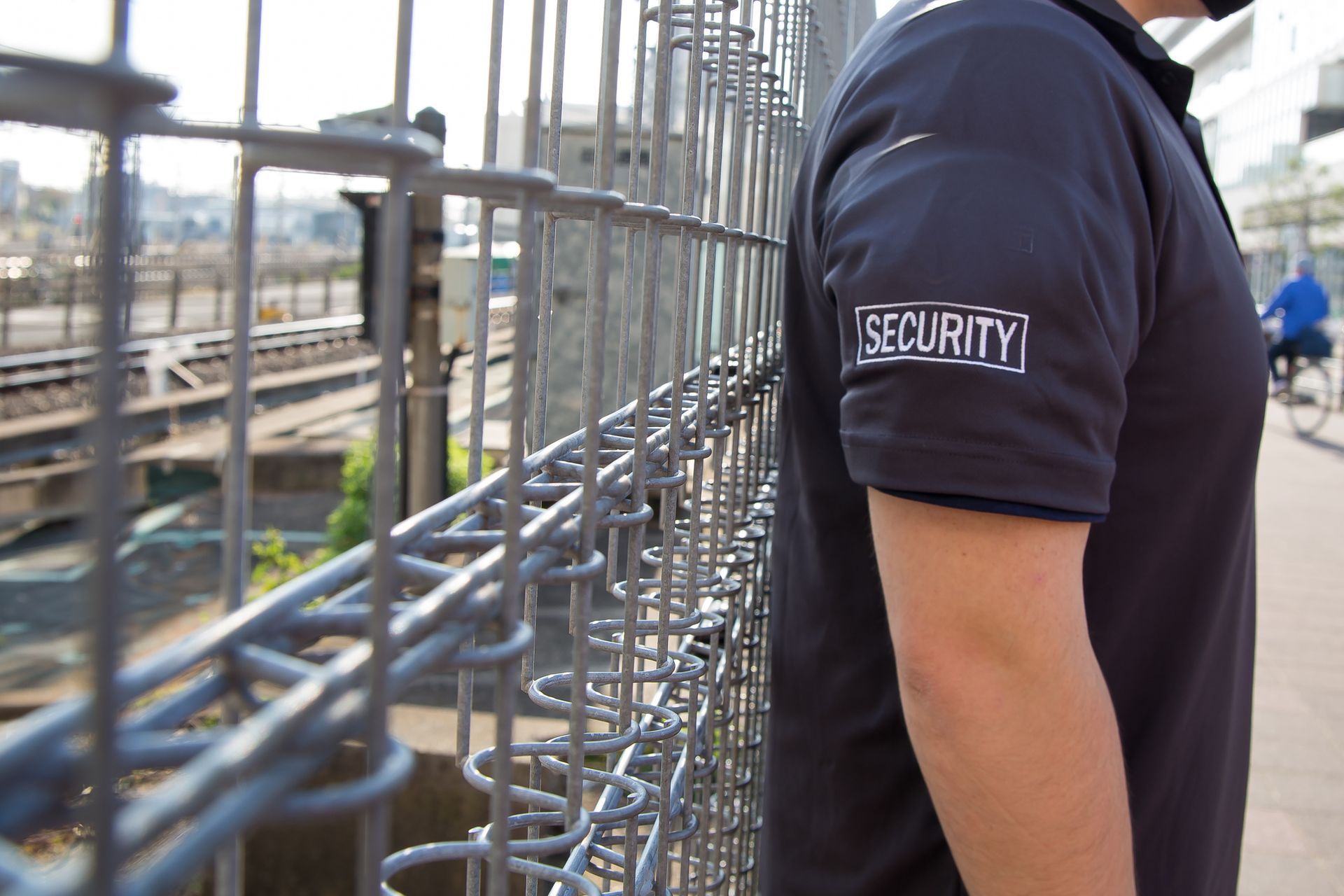 Security guard in dark blue polo shirt with 