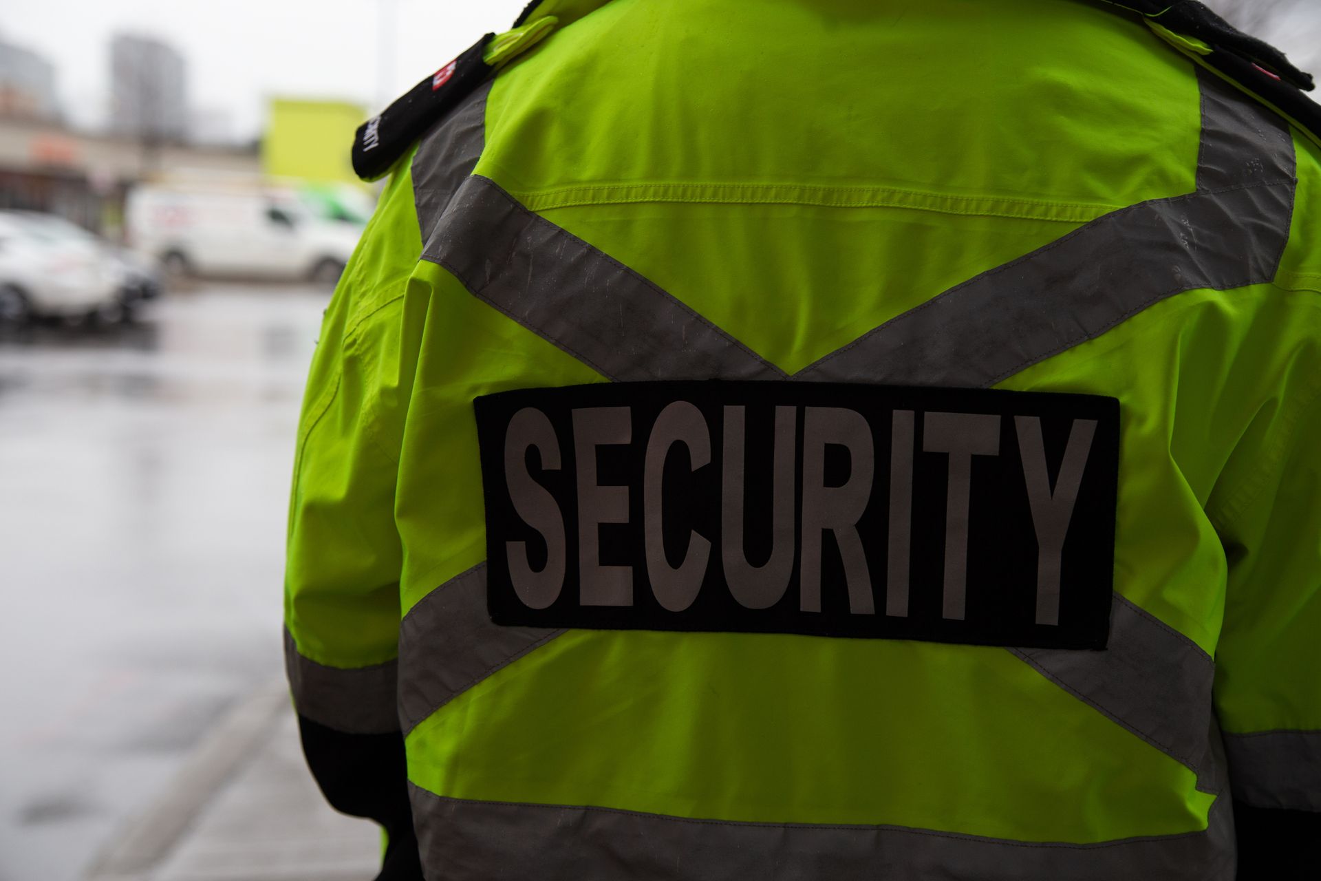 Security guard in bright yellow vest with 