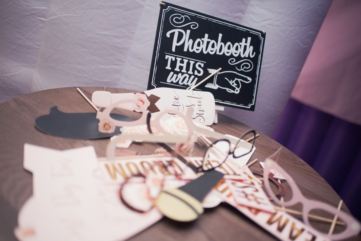 Photo booth sign with props on a table