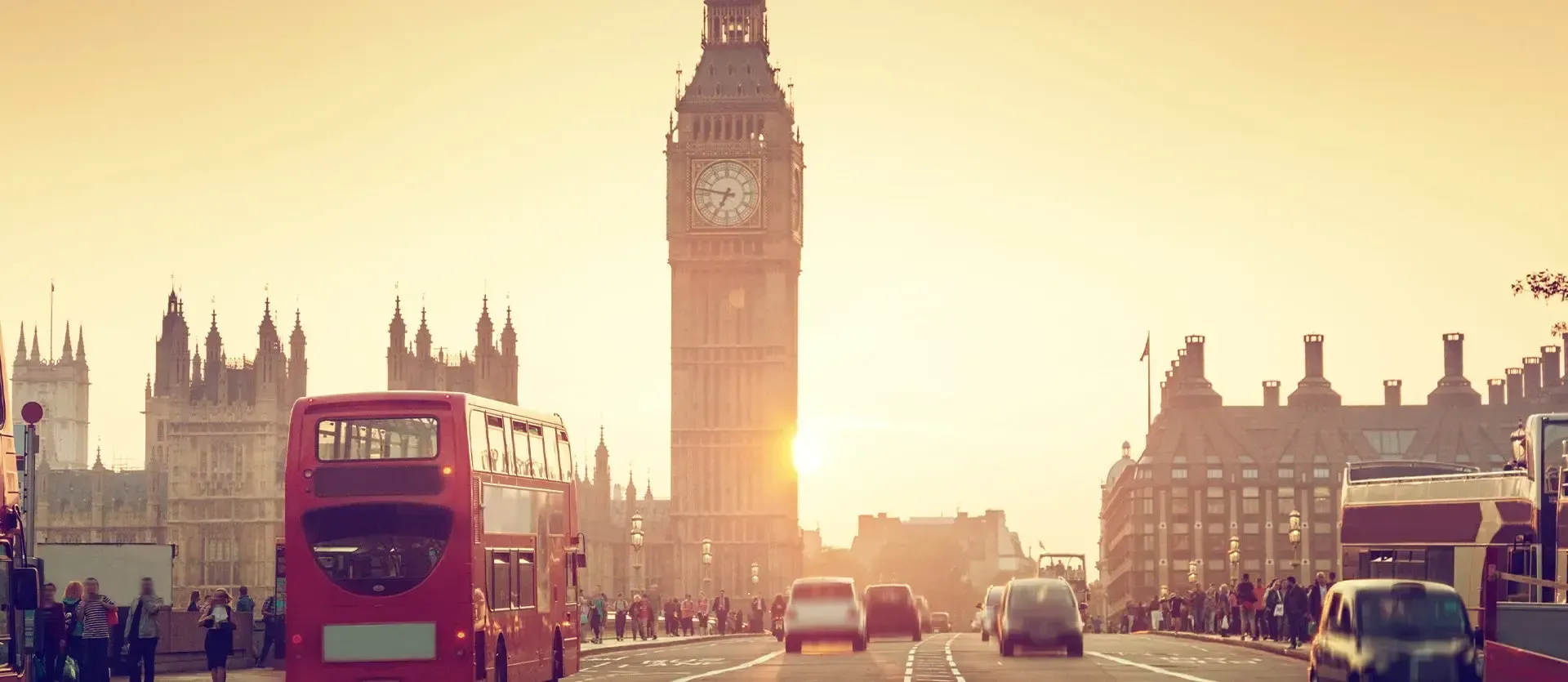 Sunset over Westminster Bridge with Big Ben and a red double-decker bus in London