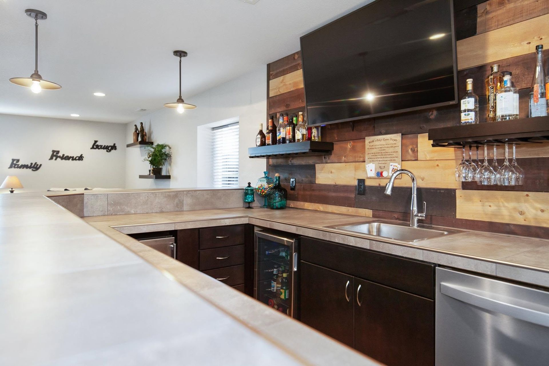Bright open-concept kitchen and living room with large windows, vaulted ceiling, and modern furnishings