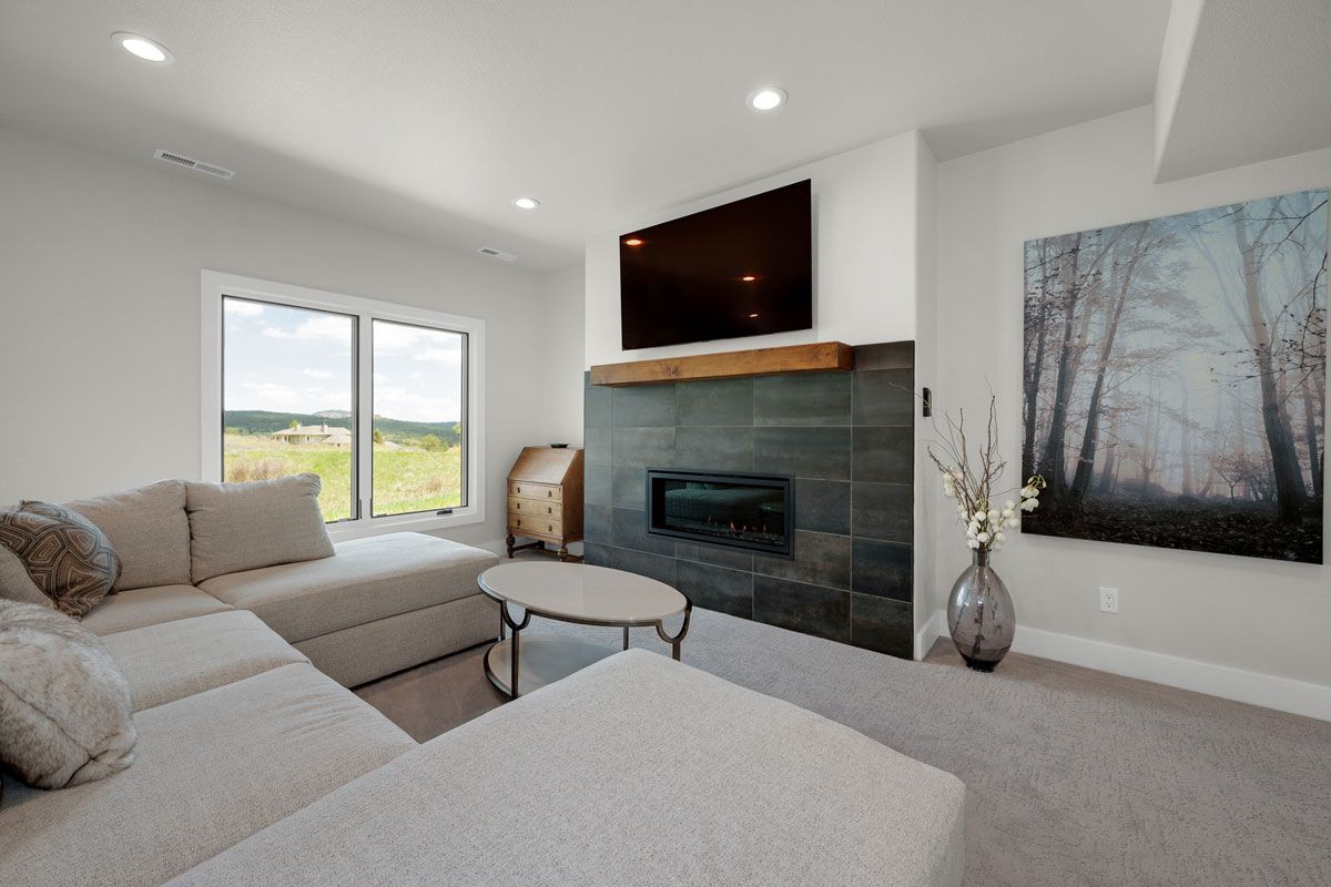 Bright kitchen with wood floors, white cabinetry, granite counters, and a stainless steel refrigerator and oven.