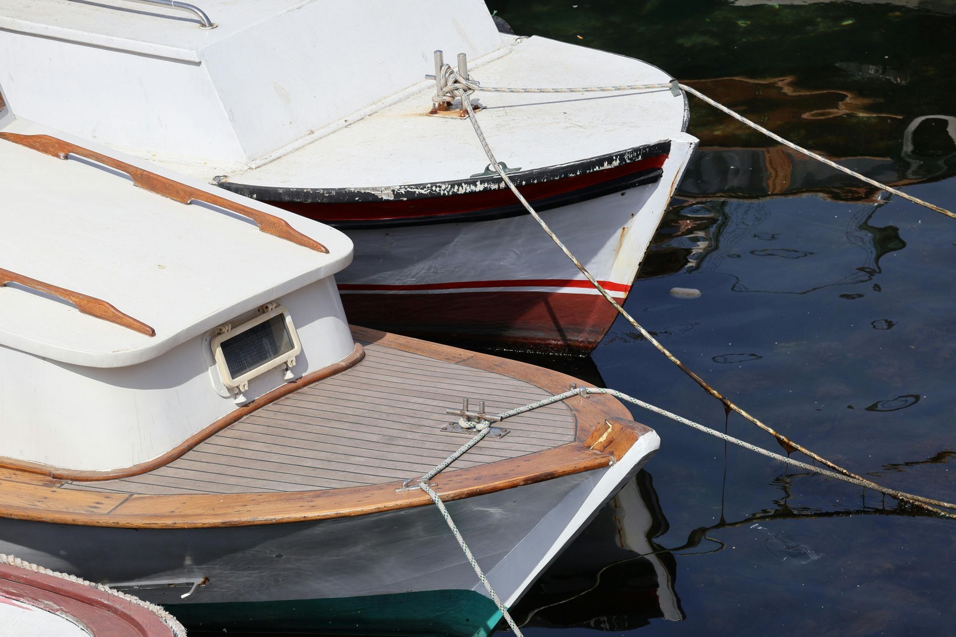 Three boats are tied to each other in the water