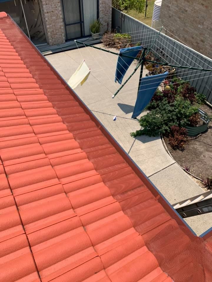 Red tiled roof with gutter, looking down on a concrete patio, clothesline, and garden — Gutter Guard In South West Rocks, NSW
