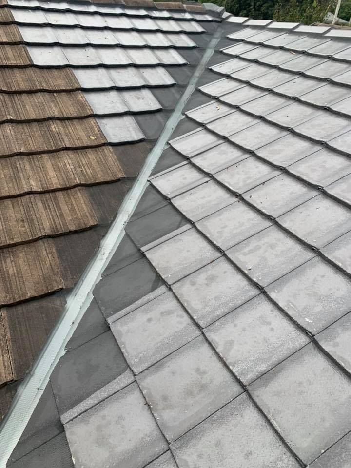 A Close Up Of A Gutter On A Roof With A Red Tile Roof — Gutter Guard In Forster, NSW