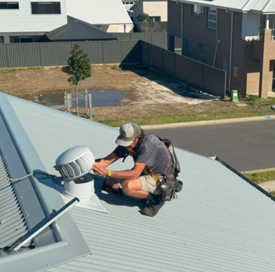 The Roof Of A House With A Wind Turbine On It — Gutter Guard In Taree, NSW