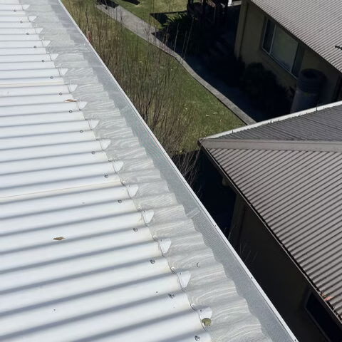 A Close Up Of A Gutter On The Side Of A House — Gutter Guard In Lake Cathie, NSW