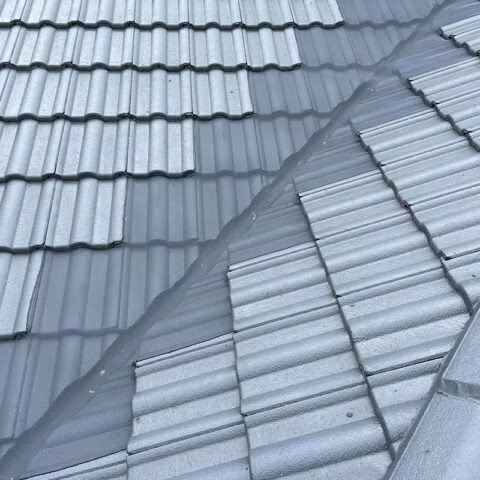A Close Up Of A Metal Roof With A Gutter On It — Gutter Guard In Lake Cathie, NSW