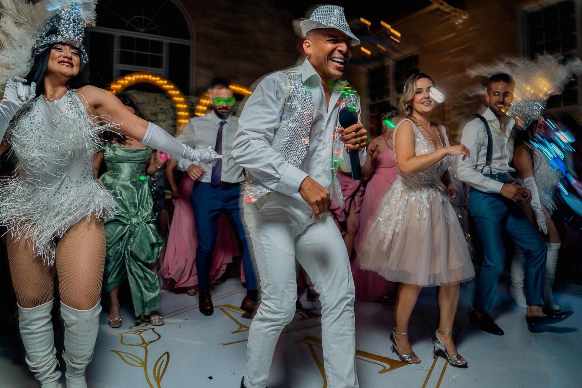 A group of people are dancing on a dance floor at a party.