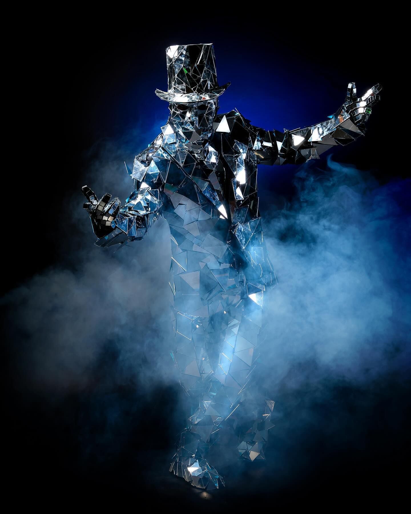 A man in a top hat is surrounded by smoke.