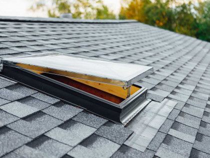 There is a skylight on the roof of a house.