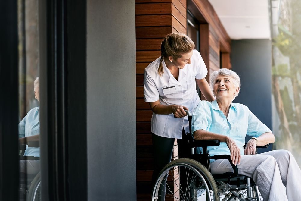 woman in a wheel chair being pushed by a nurse