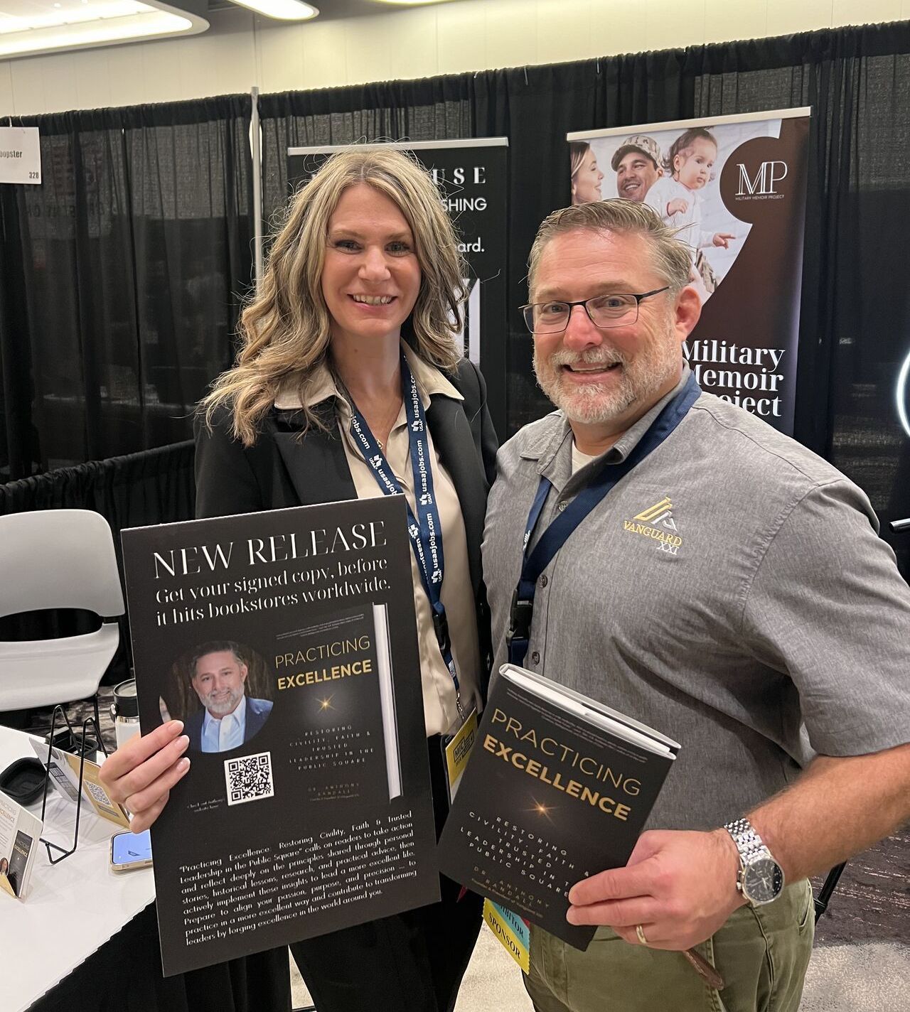 Coaching A man and a woman are standing next to each other holding books.