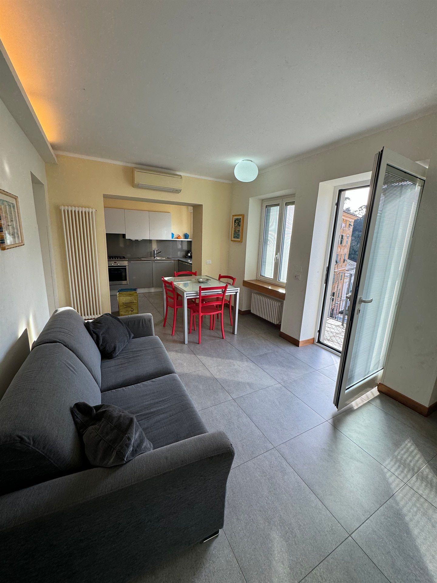 A living room with a couch , table and chairs.