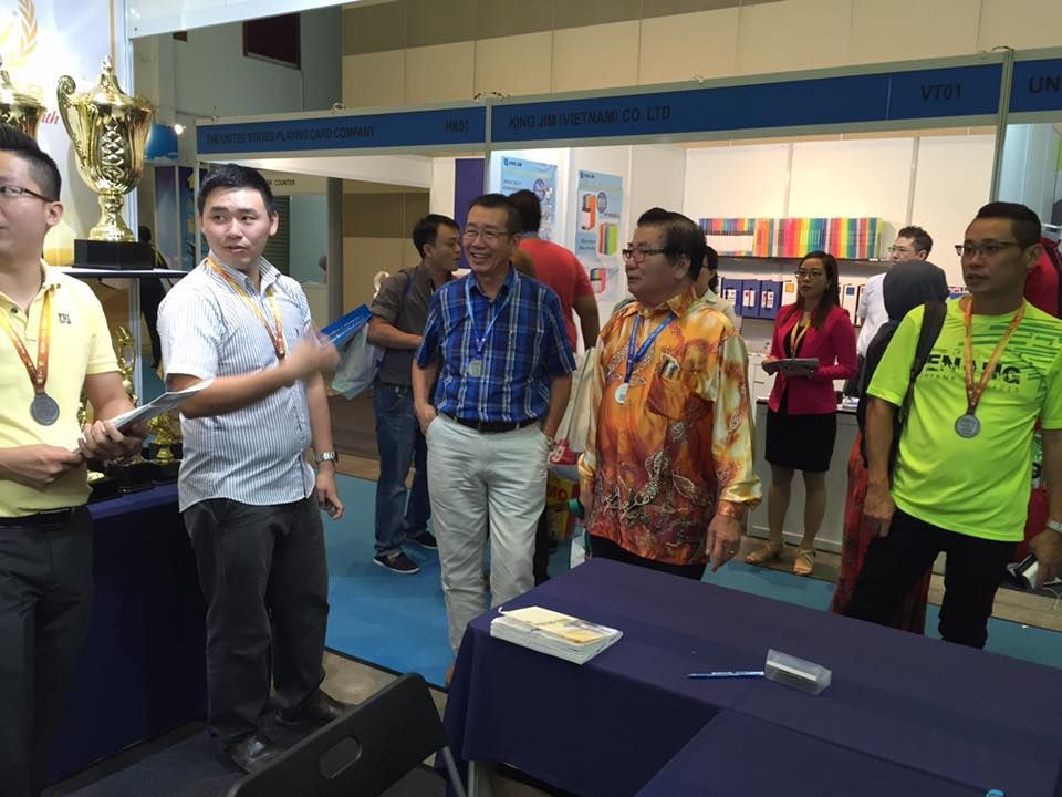 Team showing our booth products to visitors — featuring Baguss Enterprise trophies and medals at the exhibition.