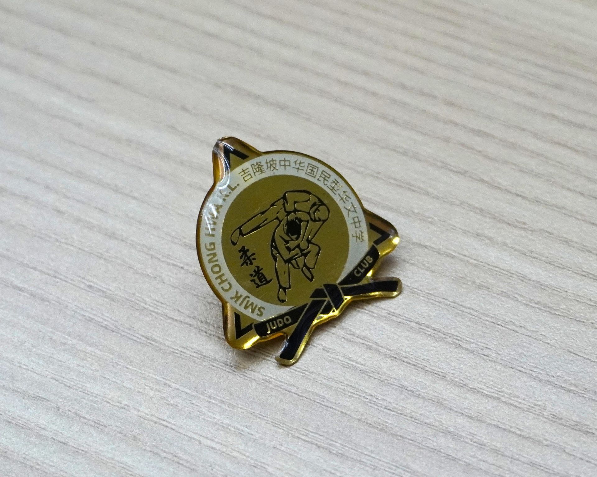 Custom collar pin with gold-plated finish and company logo