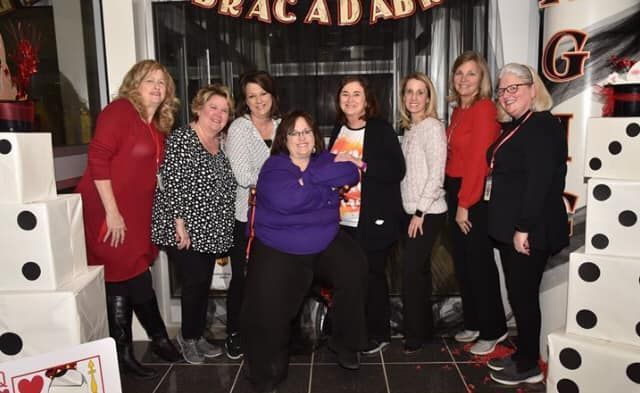 A group of women are posing for a picture in front of a casino.