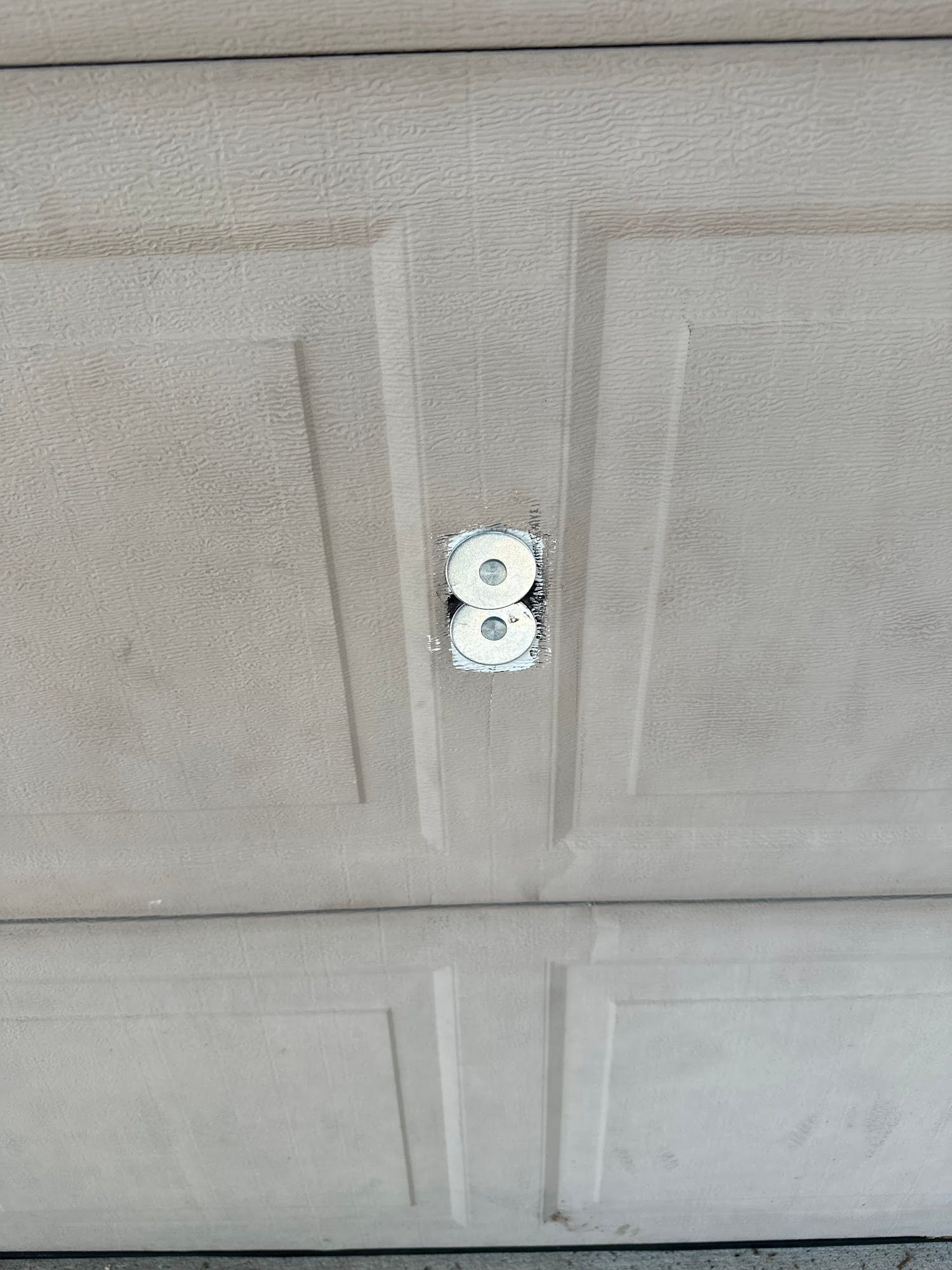 Close-up of a light gray garage door with the number 8 on it.