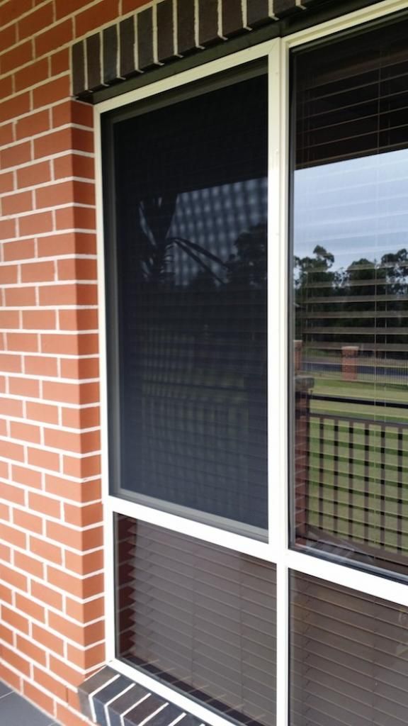 A brick building with a screen door on it