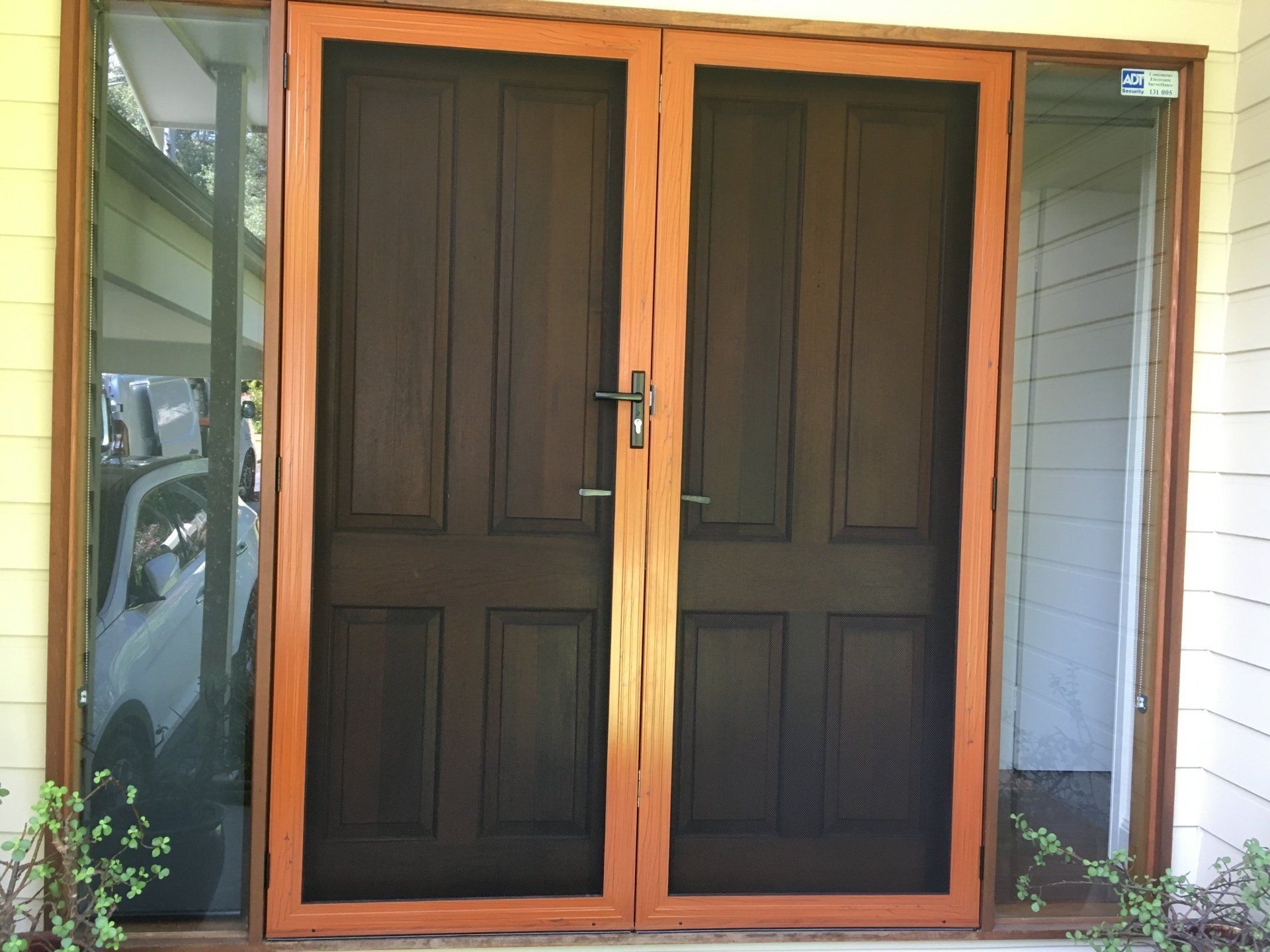 A wooden door with a screen on it