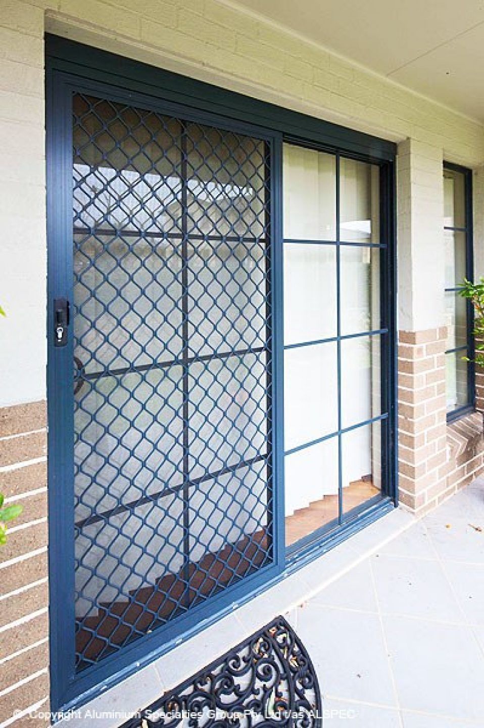 There is a sliding glass door with a security screen on it.