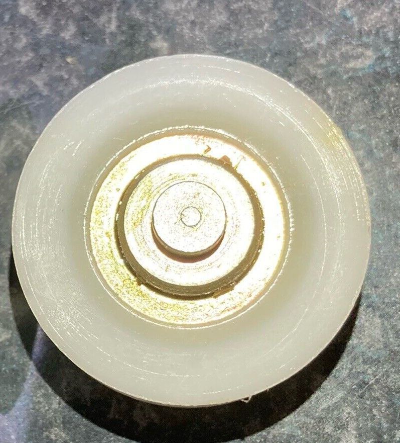 A white circle with a gold center is sitting on a table.