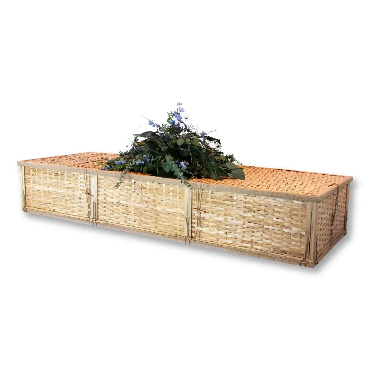 Long wicker planter box with a leafy green plant on top, isolated on a white background