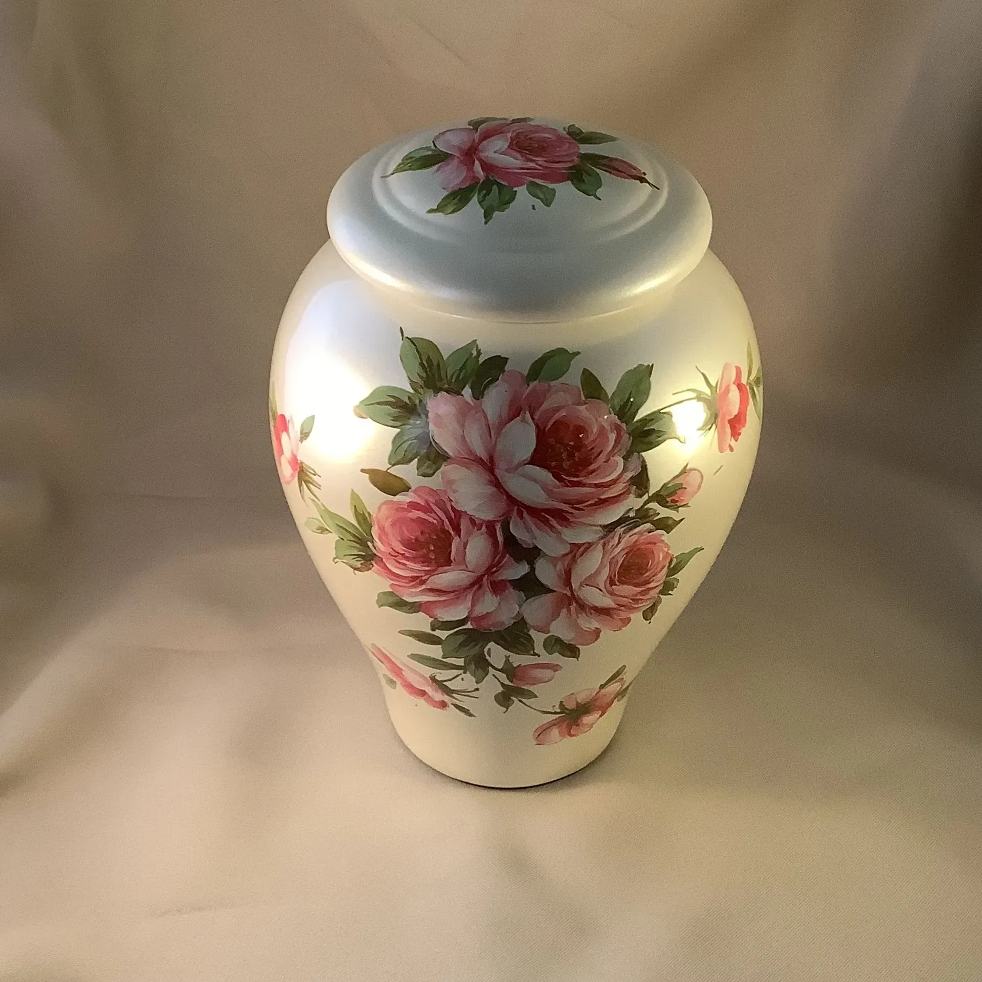 White porcelain vase with pink rose floral decorations and a matching lid