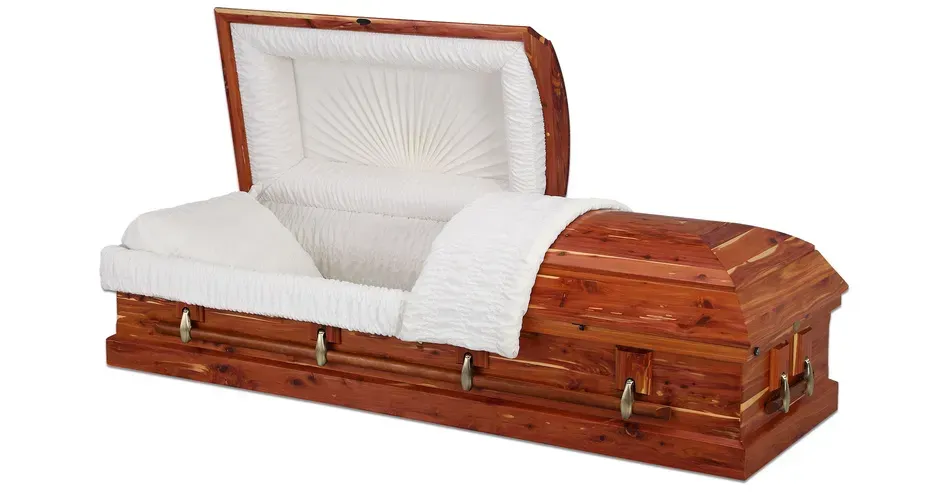 White-lined wooden coffin with an open lid and brass handles