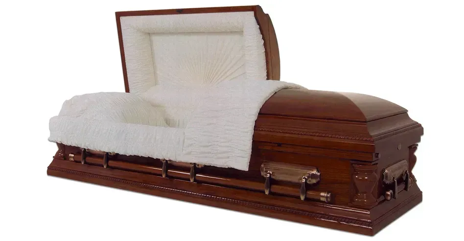Brown wooden coffin with white lining and lid open on a white background