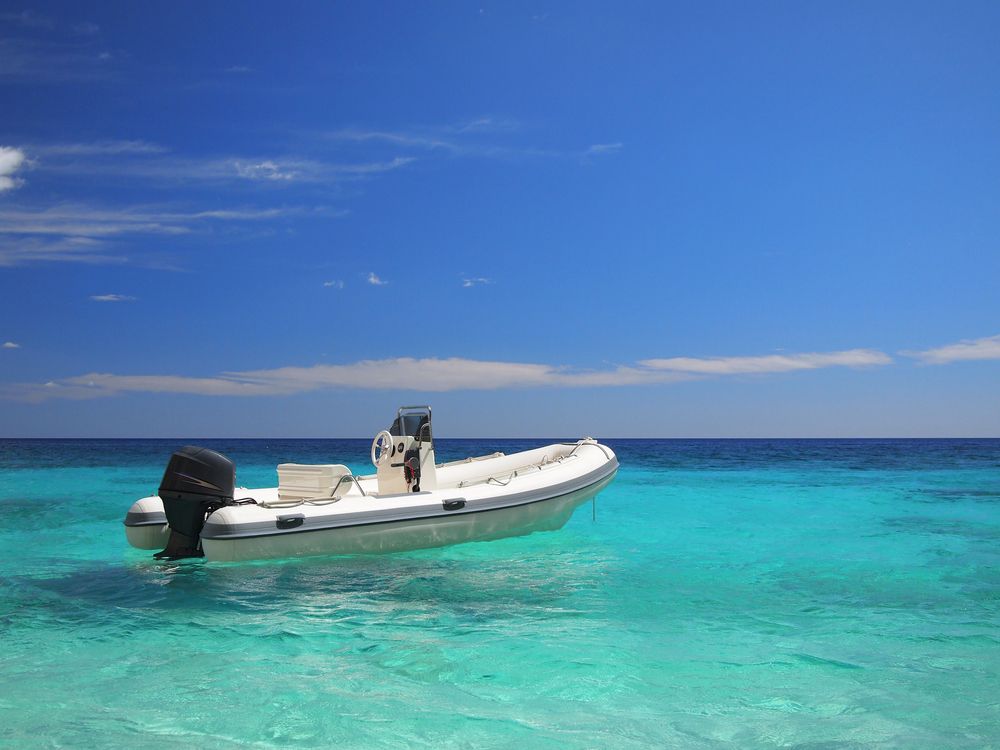 A White Boat is Floating on Top of a Turquoise Ocean — Crane Maintenance Queensland in Emerald, QLD