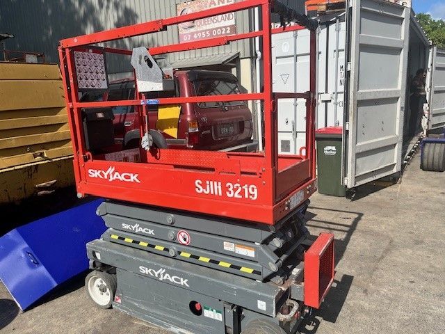 A Car is Being Repaired in a Garage With a Blue Jack — Crane Maintenance Queensland in Slade Point, QLD