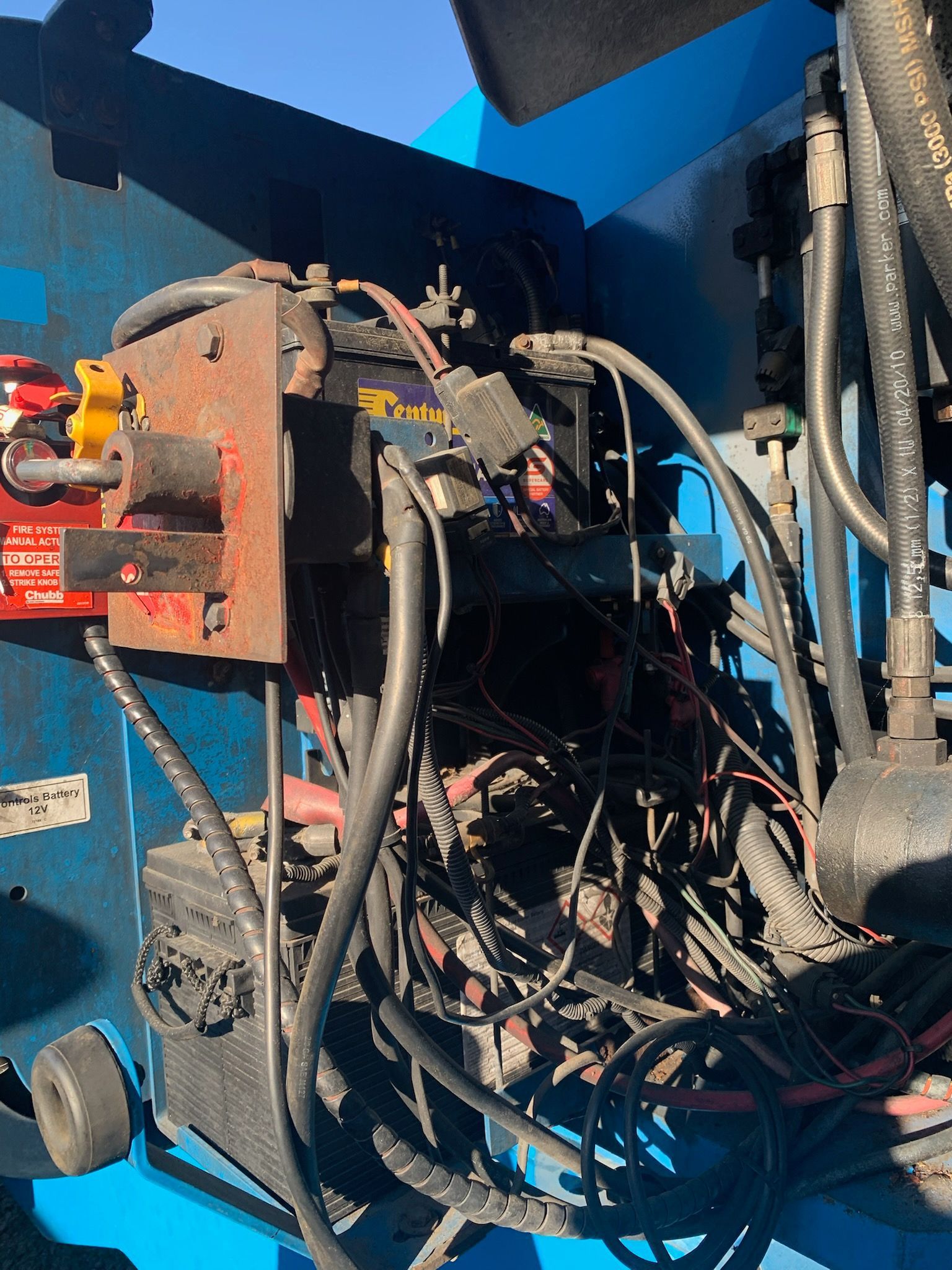 A Man is Working on a Car Engine in a Garage — Crane Maintenance Queensland in Slade Point, QLD