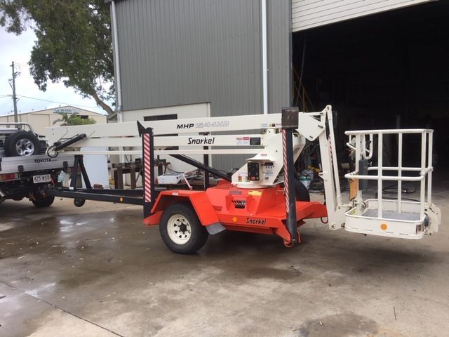 A Mechanic is Working on the Engine of a Car — Crane Maintenance Queensland in Slade Point, QLD