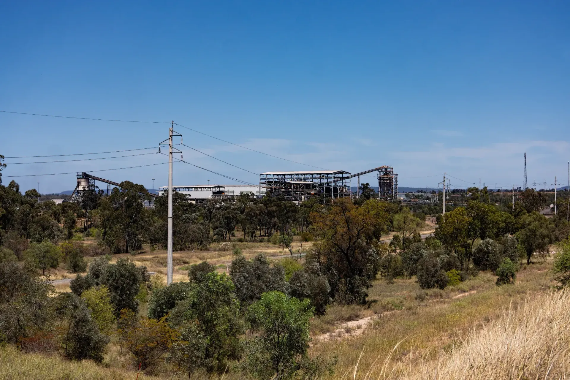 A Large Building is Sitting in the Middle of a Field Surrounded by Trees — Crane Maintenance Queensland in Moranbah,QLD