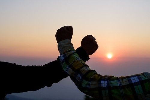 Arms Crossed - Working Together at Sunset