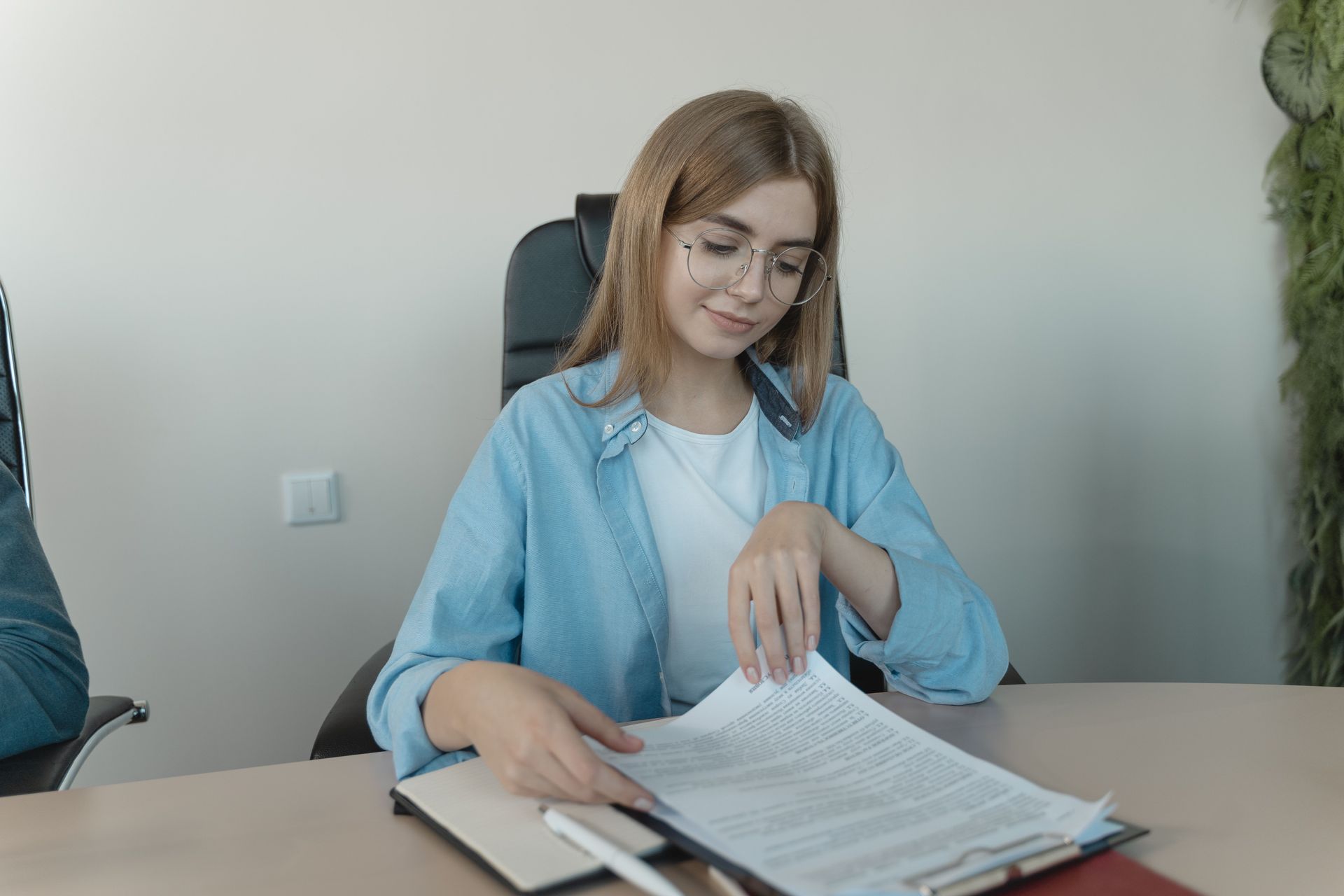 HR business partner reviewing paperwork at her desk while balancing compliance work and open recruit
