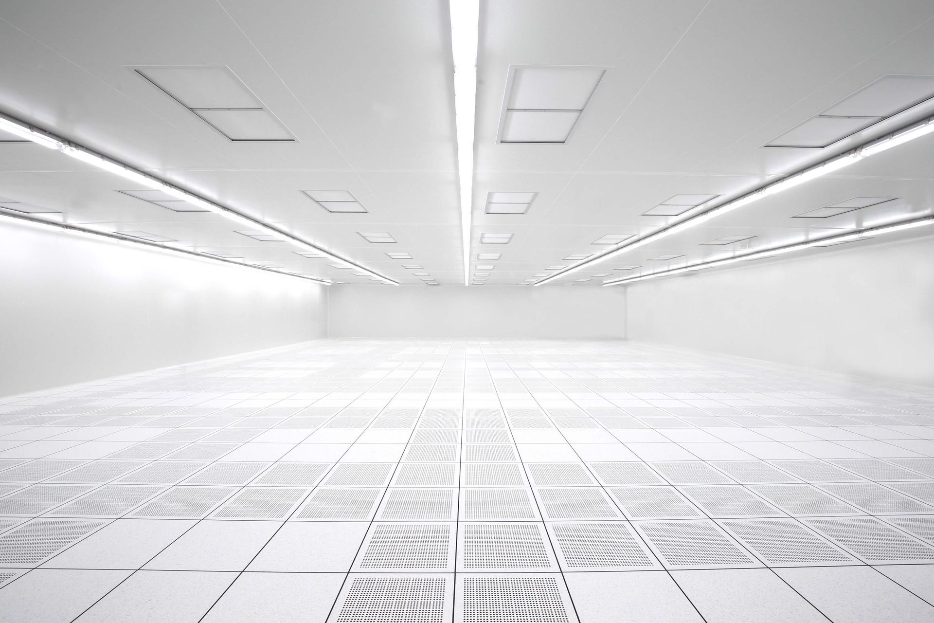 Bright white, empty room with tiled floor, rectangular ceiling lights.