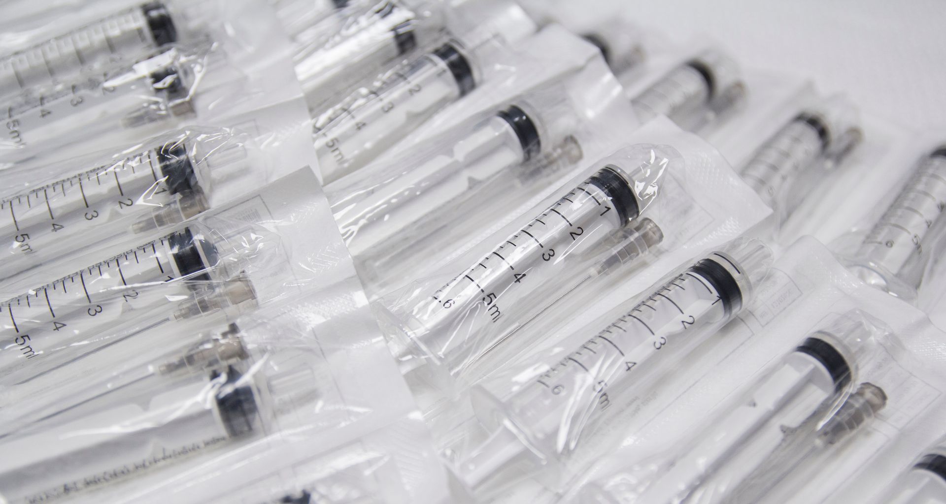 Sealed syringes in transparent packaging, likely for medical use.