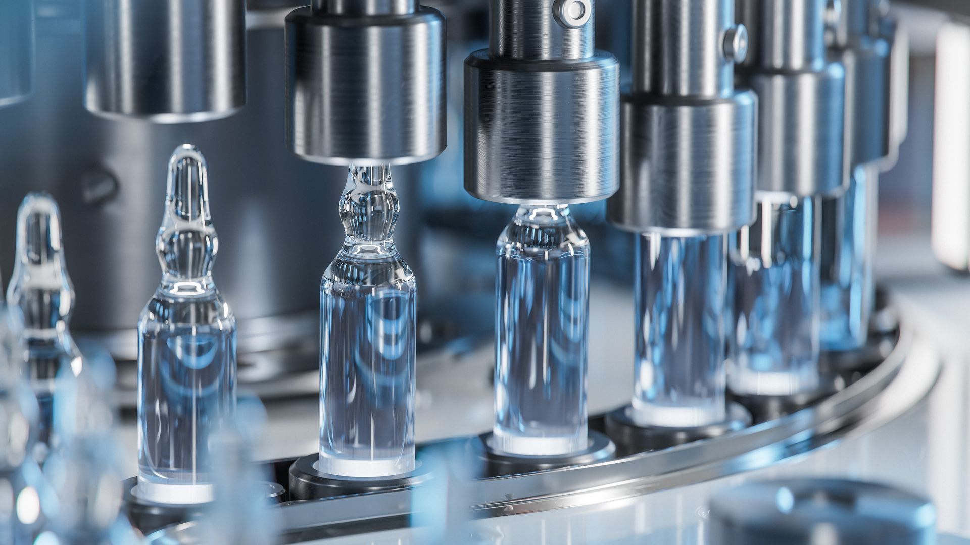 Automated pharmaceutical filling machine dispensing liquid into glass vials.