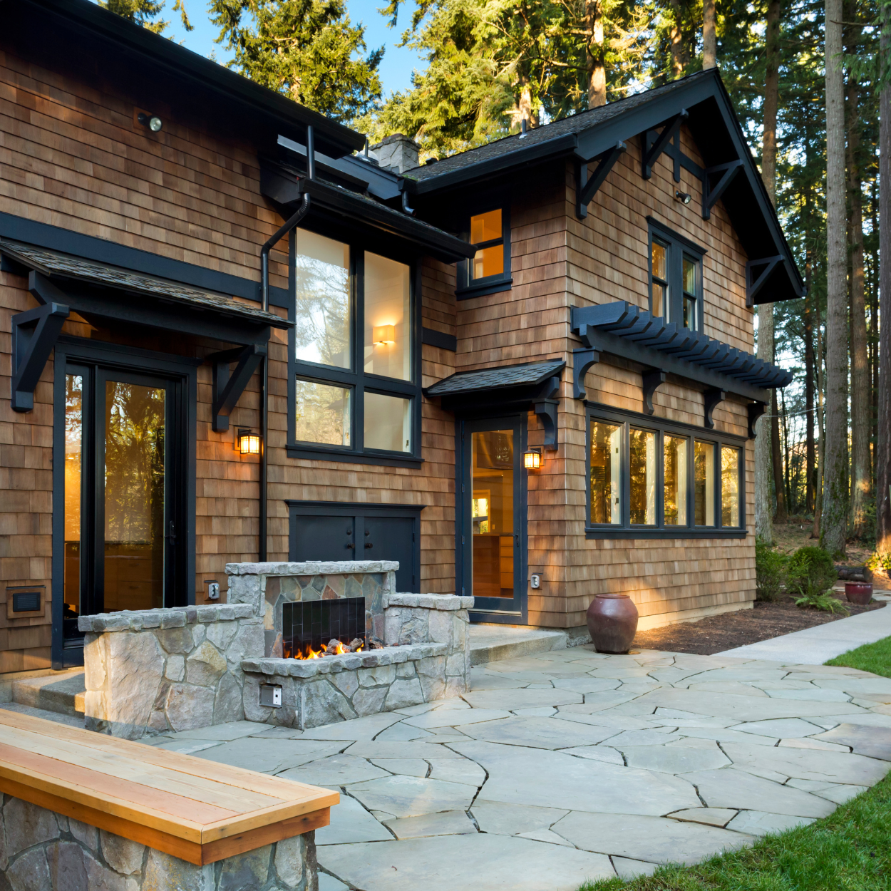 a brick house with a stone fireplace in front of it